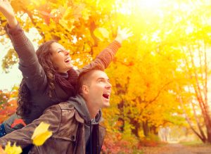 couple happy in fall leaves